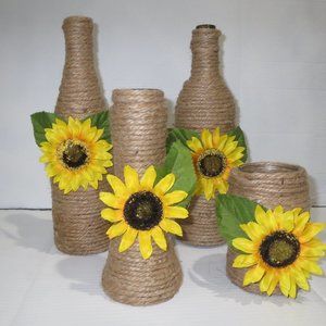 4 Jute wrapped sunflower decorated wine bottles.